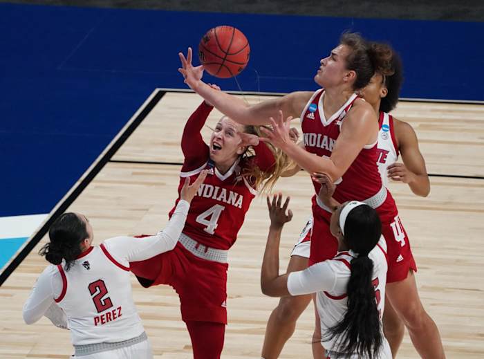 Mar 27, 2021; San Antonio, Texas, USA; Indiana Hoosiers guard Nicole Cardano-Hillary (4) and forward Aleksa Gulbe (10) battle for the ball against NC State Wolfpack guard Raina Perez (2) in the Sweet Sixteen of the 2021 Women's NCAA Tournament at Alamodome.