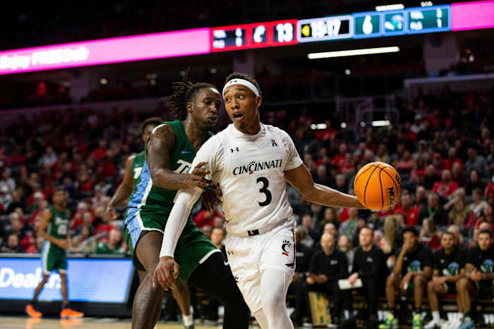 Cincinnati Bearcats guard Mika Adams-Woods (3) passes the ball during the first half of an NCAA men s college basketball game on Thursday, Dec. 29, 2022, at Fifth Third Arena in Cincinnati. The Bearcats defeated the Green Wave 88-77 with a crowd of 9,484. Tulane Green Wave At Cincinnati Bearcats Ncaa Basketball Dec 29