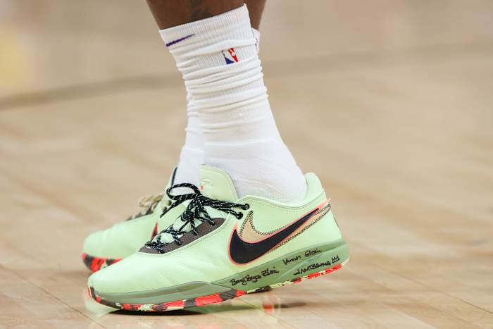 View of green and black Nike LeBron shoes.