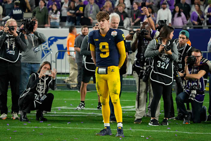 J.J. McCarthy watches TCU celebrate its win in the Fiesta Bowl.