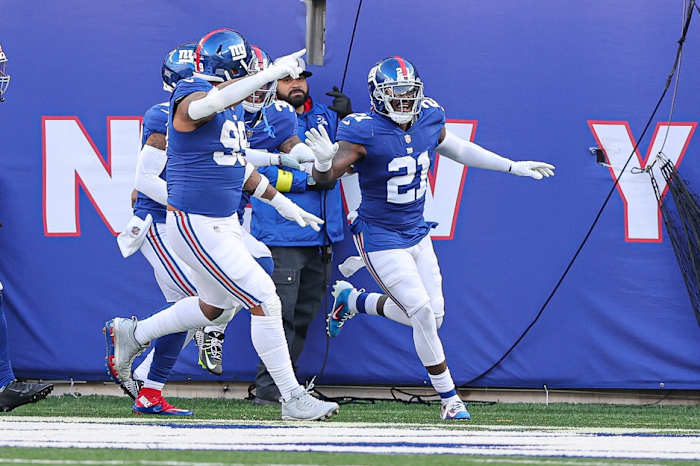 Jan 1, 2023; East Rutherford, New Jersey, USA; New York Giants safety Landon Collins (21) celebrates his interception for a touchdown with teammates during the first half against the Indianapolis Colts at MetLife Stadium.