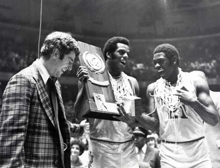 Indiana head coach Bobby Knight celebrates with forward Scott May (center) and guard Quinn Buckner (21) after winning the 1976 NCAA basketball championship. The Hoosiers beat the Wolverines 86-68.