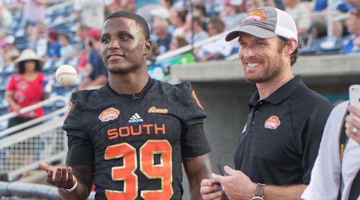 Jim Nagy strikes a pose with a player at the Senior Bowl.