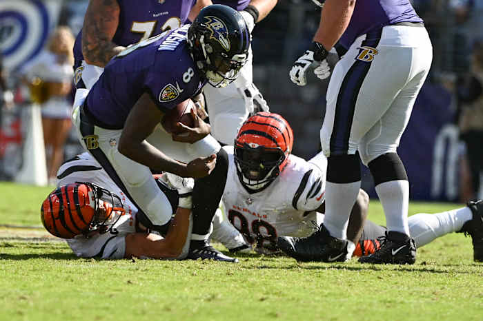 Oct 24, 2021; Baltimore, Maryland, USA; Cincinnati Bengals defensive end Sam Hubbard (94) and defensive tackle D.J. Reader (98) sack Baltimore Ravens quarterback Lamar Jackson (8) during the first half at M&T Bank Stadium. Mandatory Credit: Tommy Gilligan-USA TODAY Sports