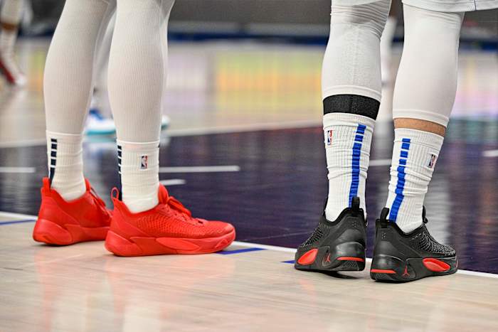 View of Pelicans center Willy Hernangomez and Mavericks guard Luka Doncic's shoes.