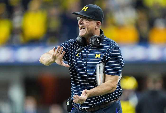 Michigan Wolverines head coach Jim Harbaugh high fives players as they leave the field during the Big Ten football championship on Saturday, Dec. 3, 2022 at Lucas Oil Stadium in Indianapolis. Michigan Wolverines defeated the Purdue Boilermakers, 43-22. Ncaa Football Big Ten Championship Football Game Purdue Boilermakers At Michigan Wolverines