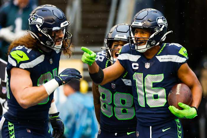 Seattle Seahawks wide receiver Tyler Lockett (16) celebrates with tight end Colby Parkinson (84) and wide receiver Cade Johnson (88) after catching a touchdown pass against the Los Angeles Rams during the third quarter at Lumen Field.