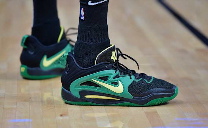 View of black, green, and yellow Nike KD shoes.