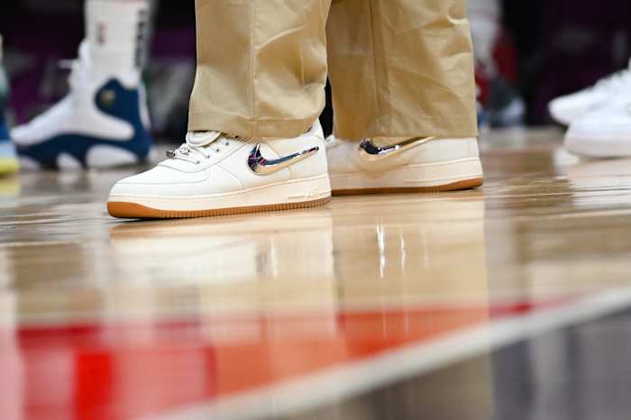 View of white and metallic Nike shoes.
