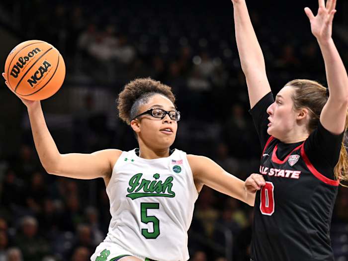 Notre Dame guard Olivia Miles passes the ball as Ball State Cardinals player Ally Becki defends.