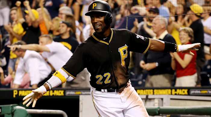 Pirates center fielder Andrew McCutchen (22) reacts after scoring the game-winning run against the Braves during the tenth inning.
