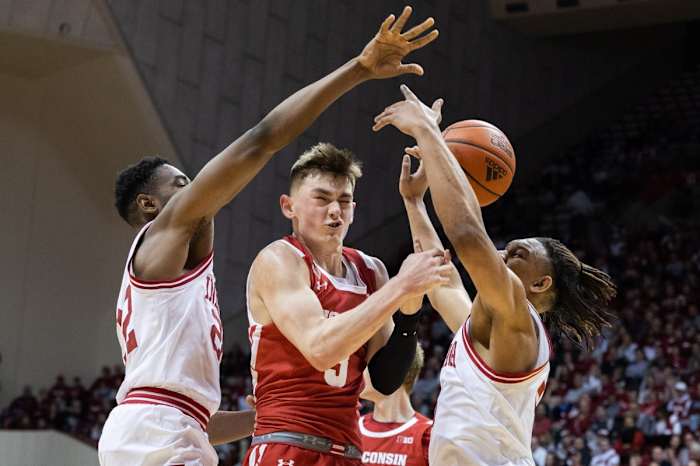 Wisconsin Badgers guard Connor Essegian (3) battles for the ball against Indiana Hoosiers forward Jordan Geronimo (22) and forward Malik Reneau (5).