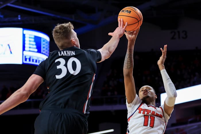 Dec 21, 2022; Cincinnati, Ohio, USA; Cincinnati Bearcats forward Viktor Lakhin (30) blocks the shot by Detroit Mercy Titans forward Gerald Liddell (11) in the second half at Fifth Third Arena. Mandatory Credit: Aaron Doster-USA TODAY Sports