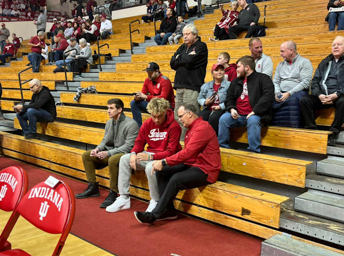 During his recruiting visit, Indiana quarterback Tayven Jackson talks with head coach Tom Allen (right) and offensive coordinator Walt Bell (left) before the Indiana basketball game against Wisconsin on Jan. 14 at Simon Skjodt Assembly Hall in Bloomington, Ind.