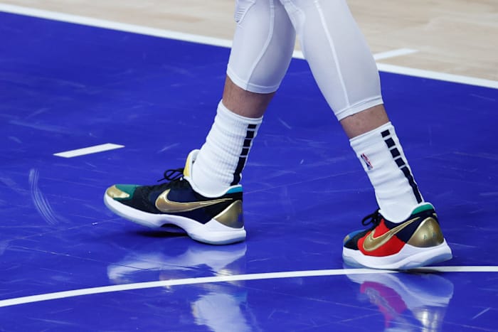 View of black, gold, and red Nike Kobe shoes.