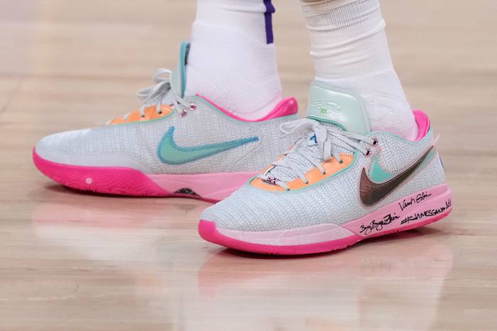 View of pink and green Nike LeBron shoes.