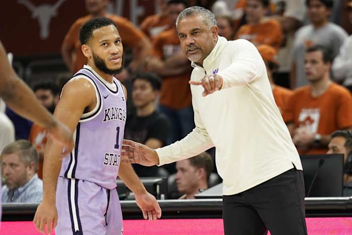 Kansas State Wildcats head coach Jerome Tang talks with guard Markquis Nowell