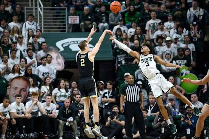 Purdue's Fletcher Loyer, left, makes a 3-pointer as Michigan State's Jaden Akins defends during the second half on Monday, Jan. 16, 2023, at the Breslin Center in East Lansing.