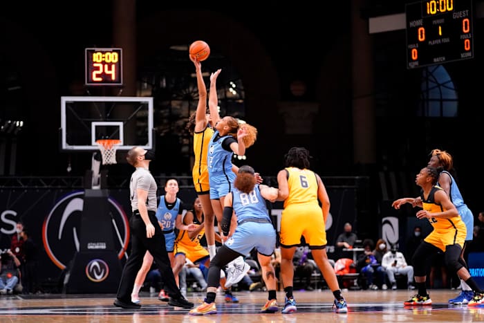 Team Mitchell forward Tianna Hawkins and forward Kiki Harrigan jump for a tip off at the start of the game