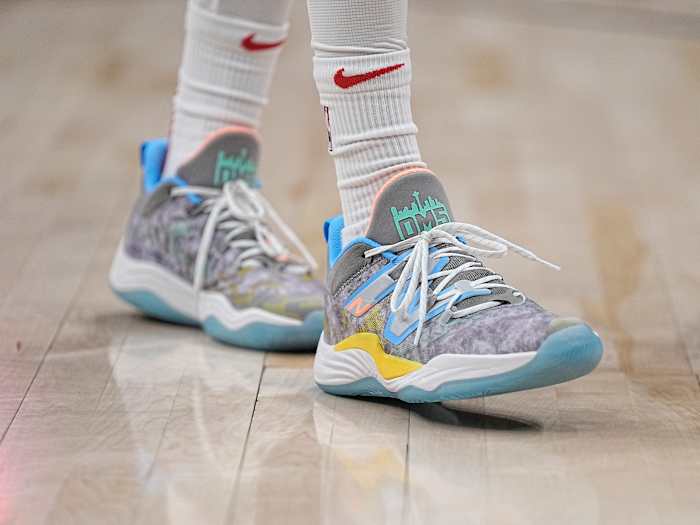 View of grey and blue New Balance shoes.