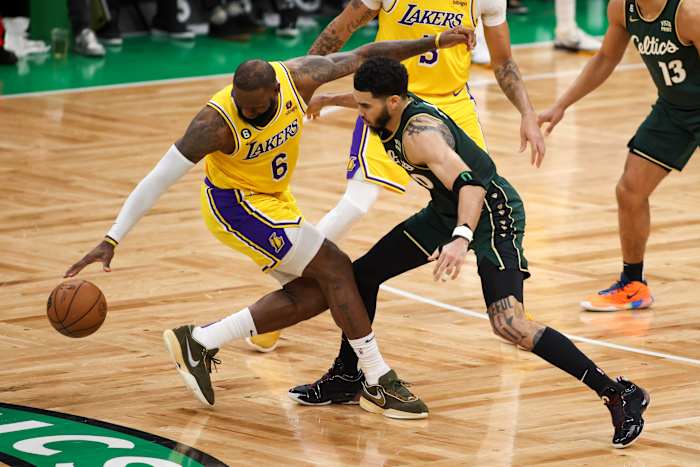 Celtics forward Jayson Tatum defends Lakers forward LeBron James.