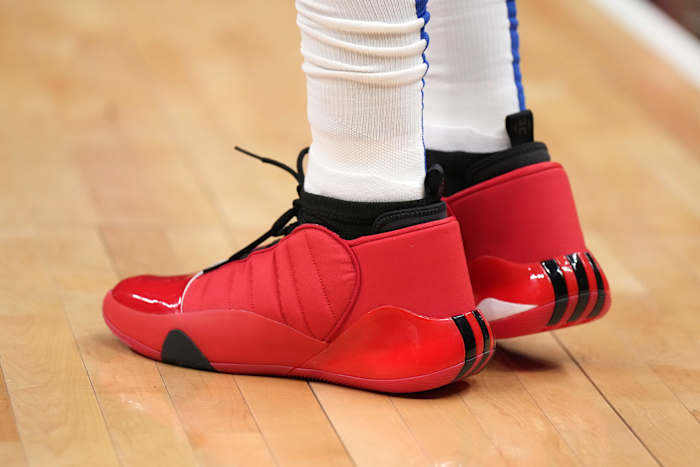 View of red and black adidas shoes.