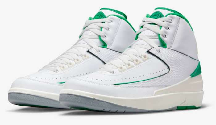 View of white and green Air Jordan shoes.