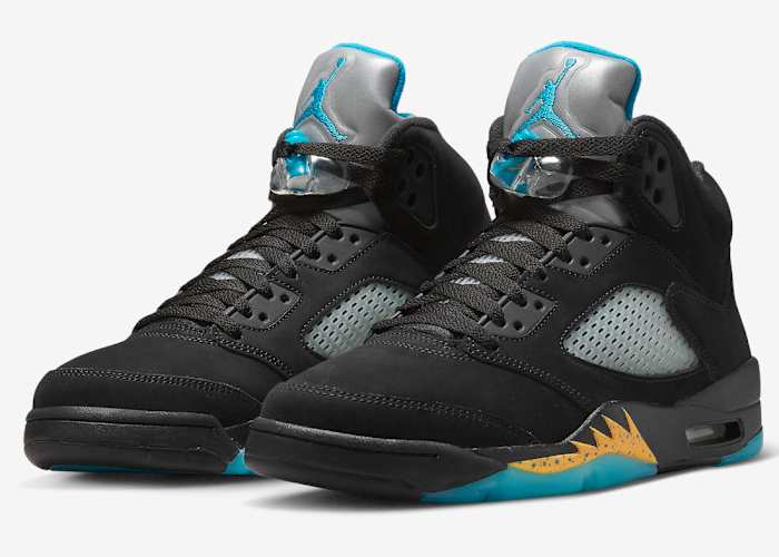 View of black and aqua Air Jordan shoes.