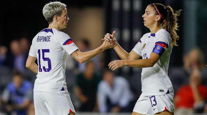 USWNT forward Megan Rapinoe celebrates with teammate Alex Morgan.