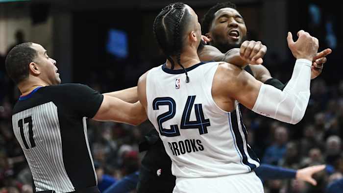 Cleveland Cavaliers guard Donovan Mitchell (45) throws a punch at Memphis Grizzlies forward Dillon Brooks