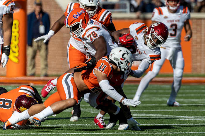 Feb 4, 2023; Mobile, AL, USA; American running back Eric Gray of Oklahoma (0) runs behind American offensive lineman Richard Gouraige of Florida (76) as National linebacker Ivan Pace Jr of Cincinnati (11) tries to break up the play during the first half of the Senior Bowl college football game at Hancock Whitney Stadium. Mandatory Credit: Vasha Hunt-USA TODAY Sports