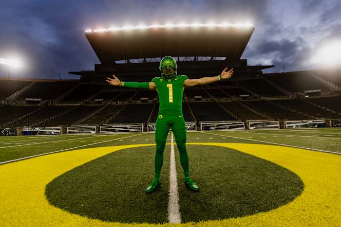 Luke Moga poses at midfield during a photoshoot inside Autzen Stadium.
