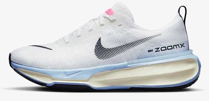 Side view of white and blue Nike shoe.