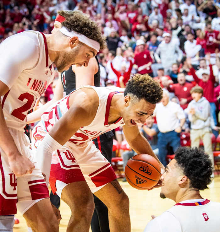 Race Thompson (25) and Trayce Jackson-Davis (23) congratulate Jalen Hood-Schifino (1) for a basket and getting fouled during their matchup with Rutgers.