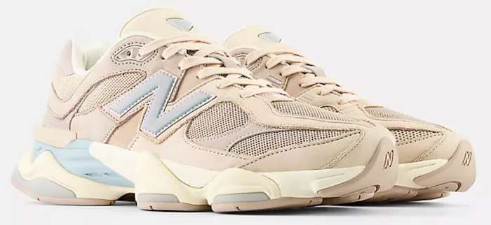 View of tan and blue New Balance shoes.