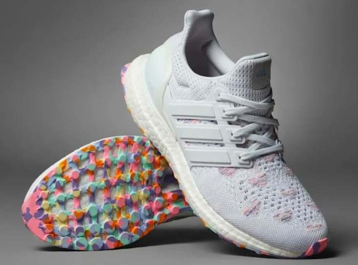 View of white and pink Adidas shoes.