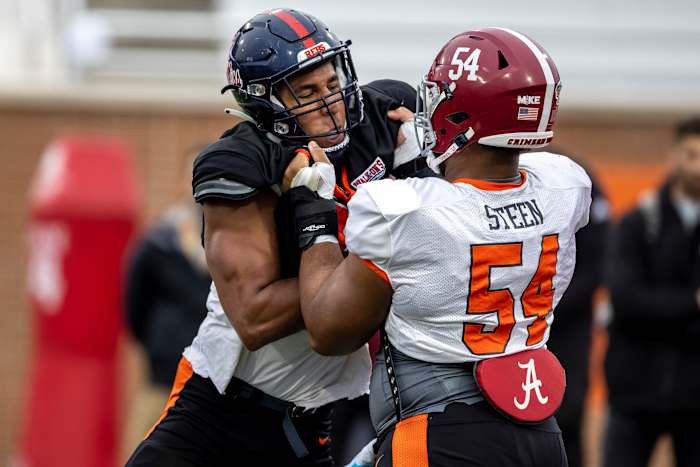 American defensive lineman Tavius Robinson of Ole Miss (92) practices with American offensive lineman Tyler Steen of Alabama (54) during the third day of Senior Bowl week at Hancock Whitney Stadium in Mobile.