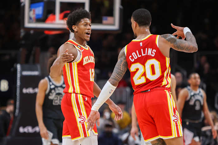 Hawks forwards De'Andre Hunter and John Collins celebrate after a made shot.