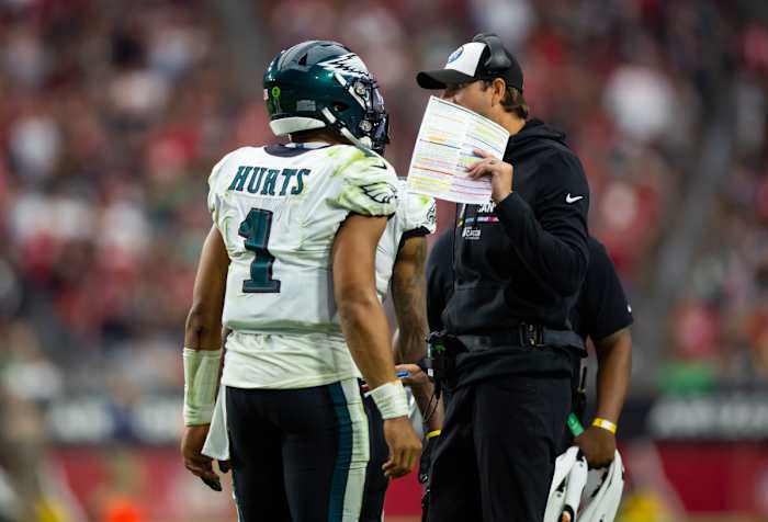 Oct 9, 2022; Glendale, Arizona, USA; Philadelphia Eagles quarterback Jalen Hurts (1) talks with offensive coordinator Shane Steichen against the Arizona Cardinals at State Farm Stadium.