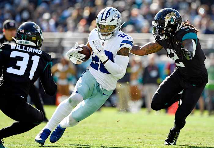 Tony Pollard evades two blockers on a running play for the Dallas Cowboys.