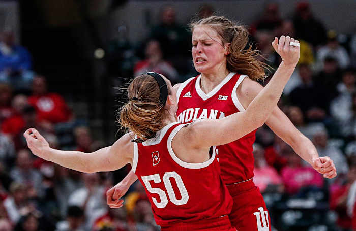 Indiana Hoosiers guard Ali Patberg (14) runs to Indiana Hoosiers forward Brenna Wise (50) for a chest bump after scoring a point during the Big Ten Semifinals at Bankers Life Fieldhouse in Indianapolis, Saturday, March 7, 2020.