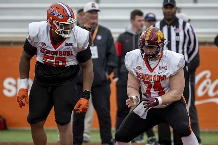 Feb 2, 2023; Mobile, AL, USA; American offensive lineman O'Cyrus Torrence of Florida (56) practices with American offensive lineman John Michael Schmitz of Minnesota (74) during the third day of Senior Bowl week at Hancock Whitney Stadium in Mobile.