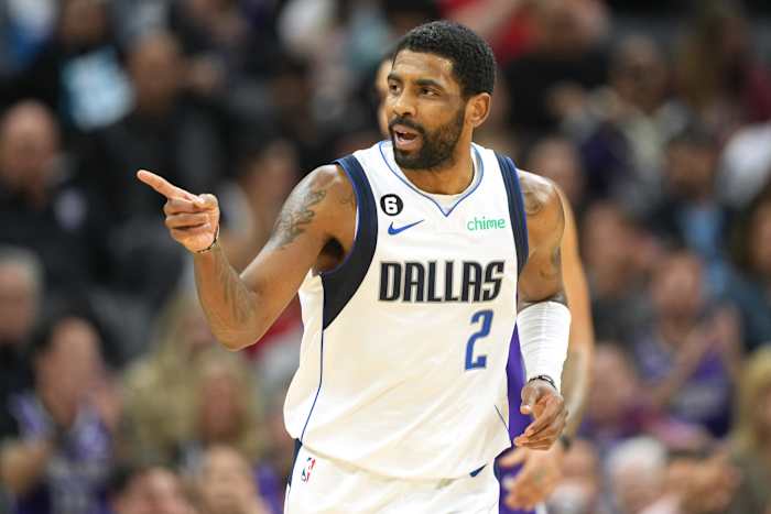 Dallas Mavericks guard Kyrie Irving points to a teammate during a game.