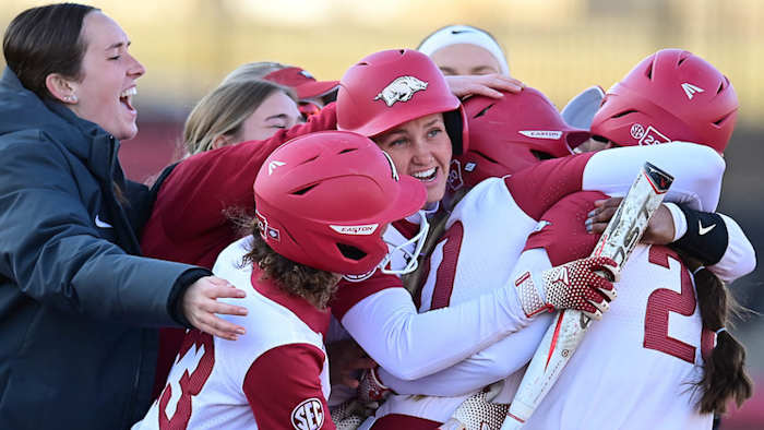 Arkansas Razorbacks celebrate a game-winning hit by Hanna Gammill in the seventh inning by Hannah Gammill on Thursday evening at Bogle Park.