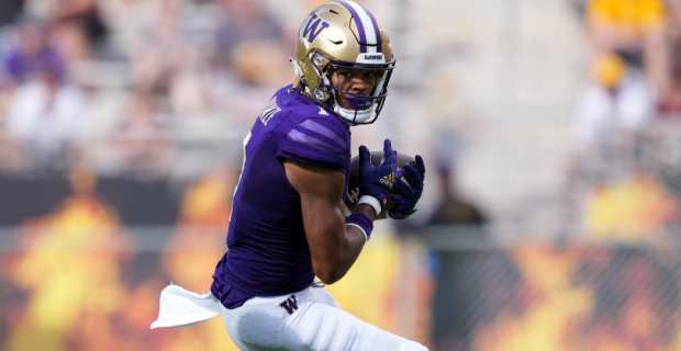 Washington Huskies wide receiver Rome Odunze on a pass during a college football game.