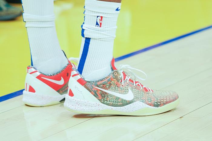 View of white and red Nike Kobe shoes.