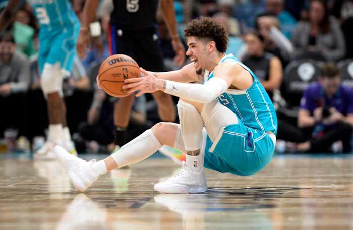 Charlotte Hornets guard LaMelo Ball falls down during a game.