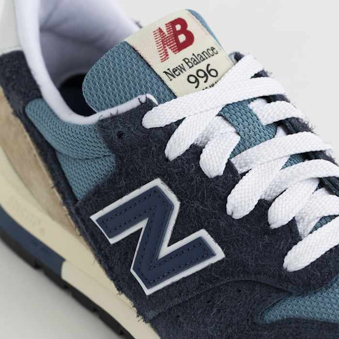 Detailed look at a blue and white New Balance shoe.