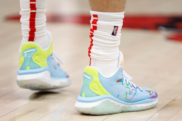 View of blue and green New Balance shoes.