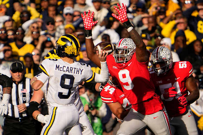 Nov 26, 2022; Columbus, Ohio, USA; Ohio State Buckeyes defensive end Zach Harrison (9) pursues Michigan Wolverines quarterback J.J. McCarthy (9) during the second half of the NCAA football game at Ohio Stadium. Michigan won 45-23. Mandatory Credit: Adam Cairns-The Columbus Dispatch Ncaa Football Michigan Wolverines At Ohio State Buckeyes